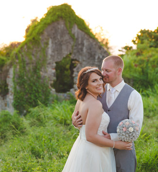 St. Croix bride and groom hugging by ruins in Rust Op Twist