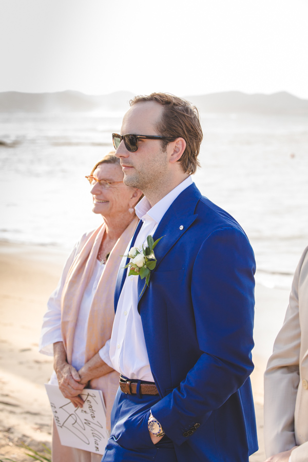 St. Croix groomstanding at the top of the aisle With a officiant