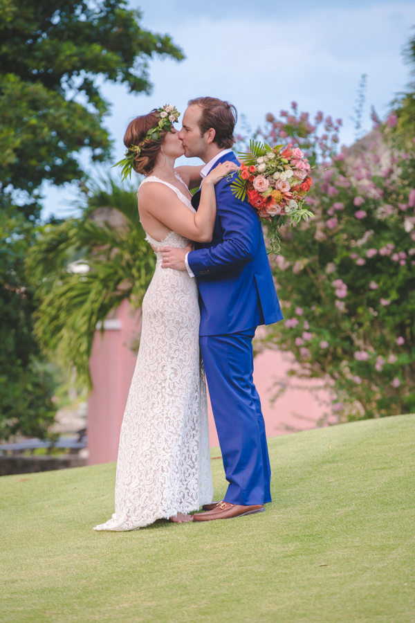 St. Croix bride and groom kissing in front of sugar mill