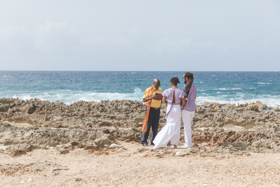 St. Croix bride and groom exchanging vows on rocky beach