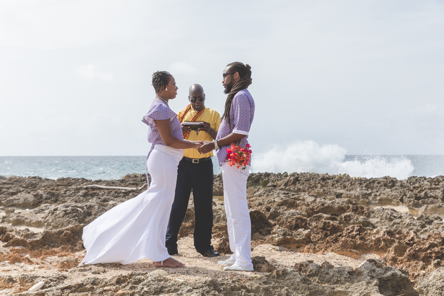 St. Croix bride and groom exchanging vows on rocky beach