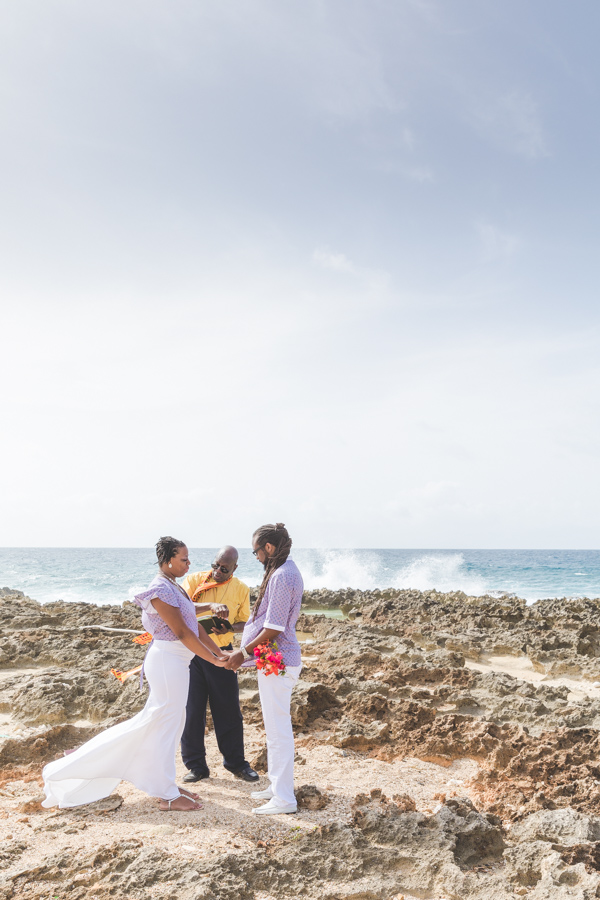 St. Croix bride and groom exchanging vows on rocky beach