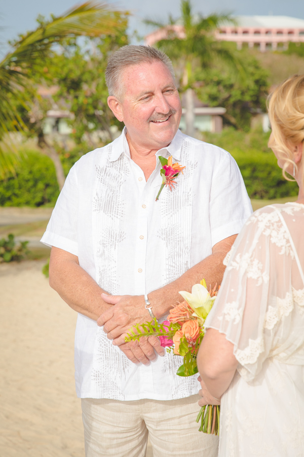St. Croix groom smiling at bride on beach