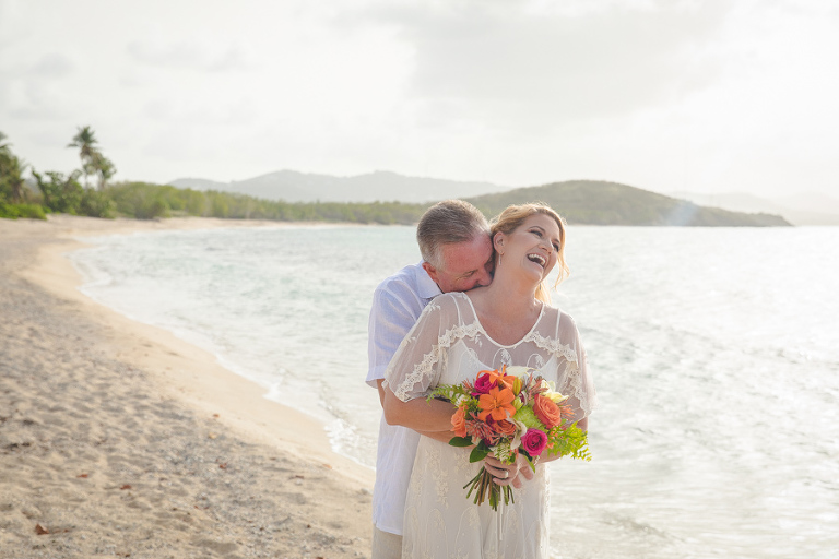 St. Croix groom holding laughing bride with bouquet bouquet