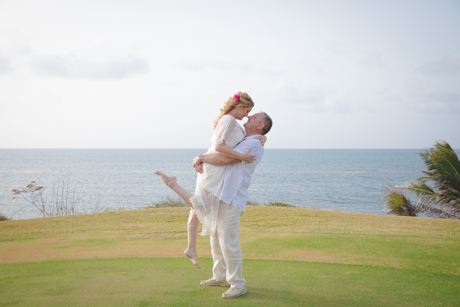 St. Croix groom lifting bride in the air while they kiss