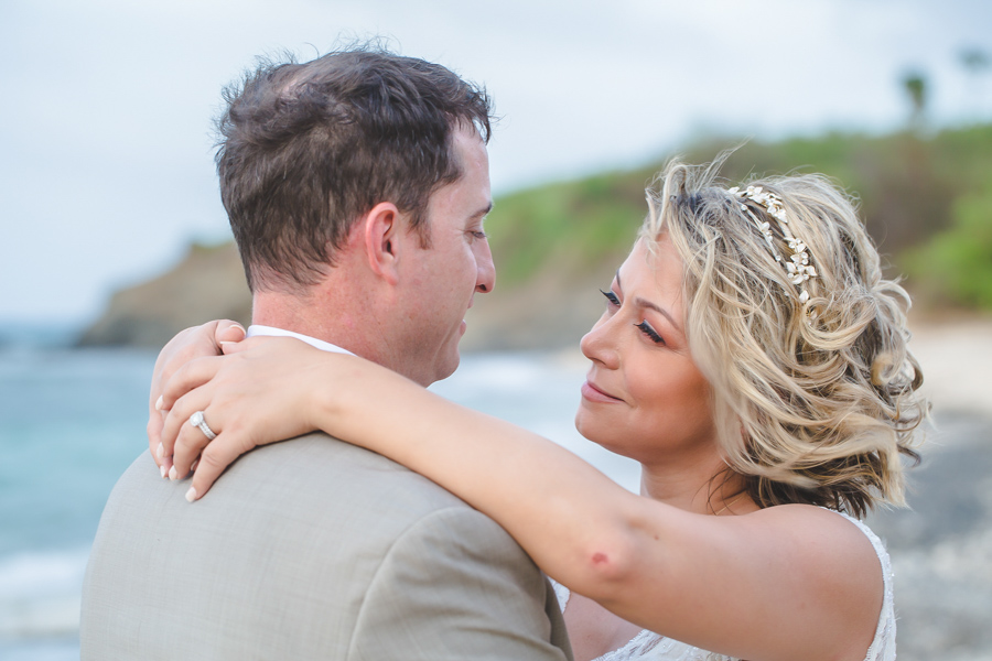 St. Croix bride and groom looking each other in the eyes on the beach