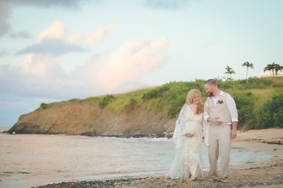 St. Croix bride and groom walking arm and arm on beach smiling