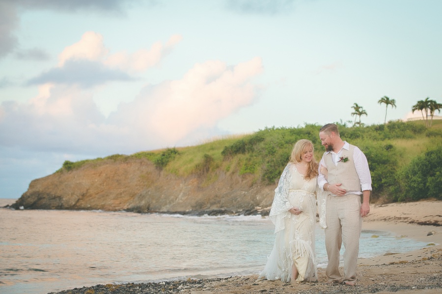 St. Croix bride and groom walking arm and arm on beach smiling